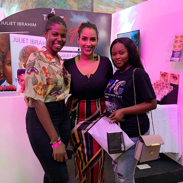 Juliet Ibrahim flanked by fans at her exhibition stand