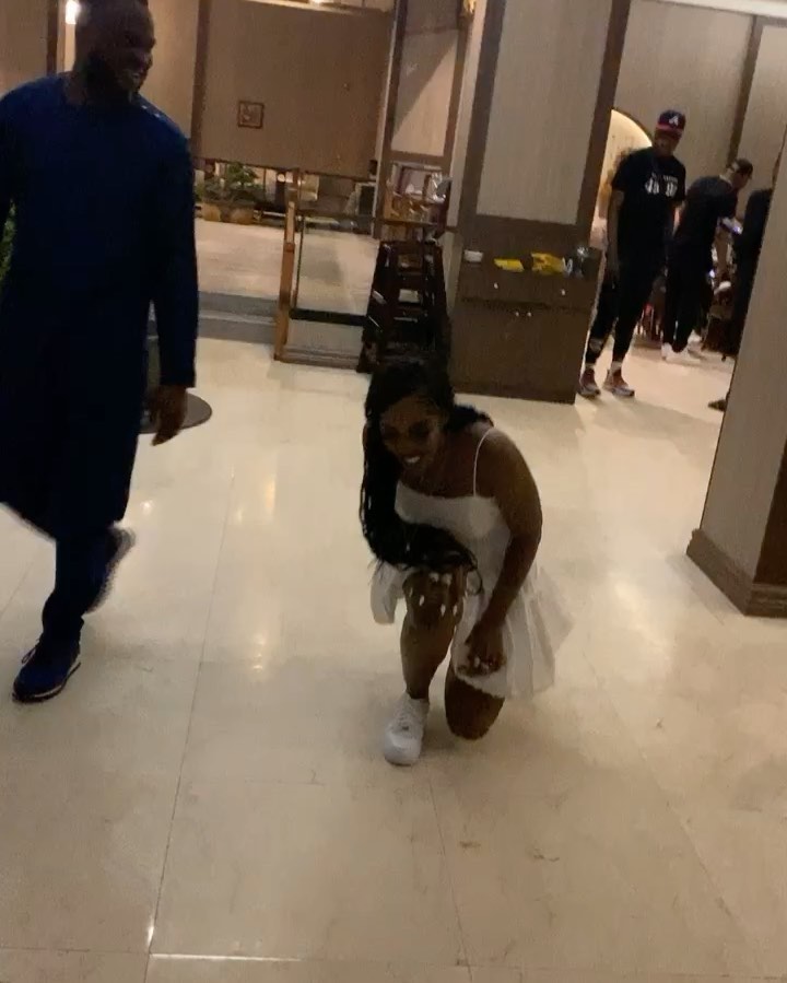 Tiwa Savage is seen in the clip kneeling down 
