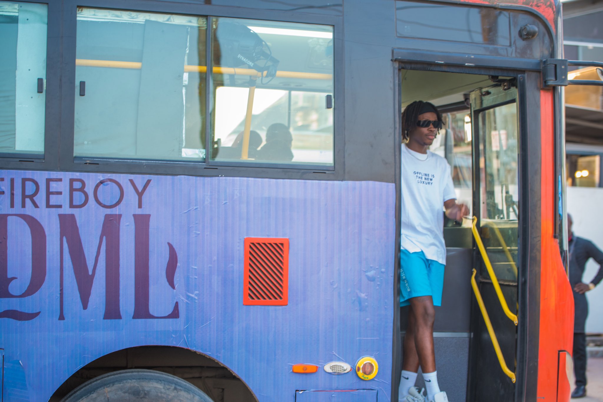 Fireboy hangs out with his fans on a bus tour 